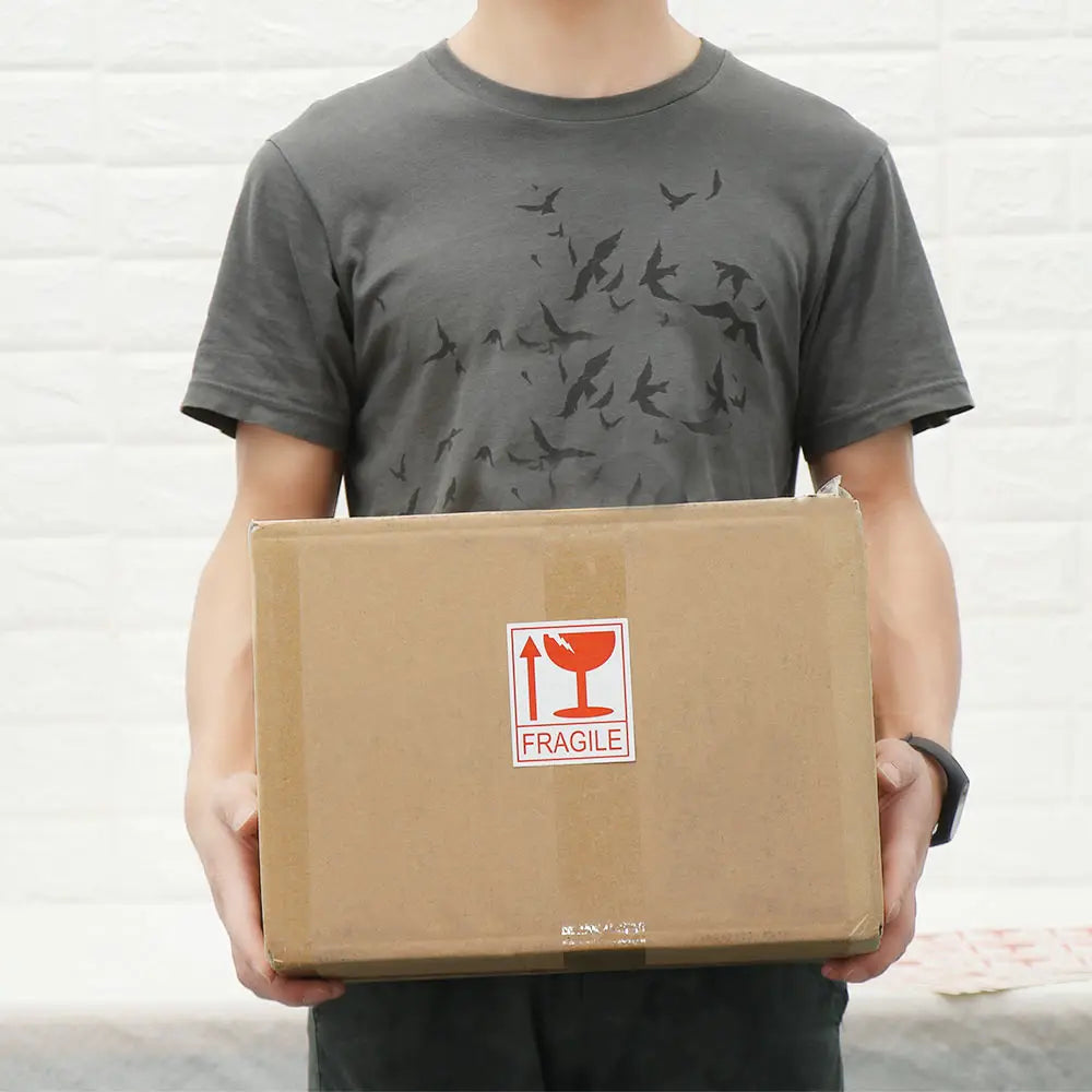 man holding box with fragile sticker